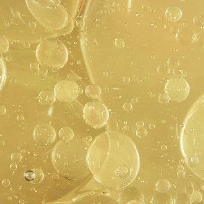 Close-up of oil and water bubbles on a gold background