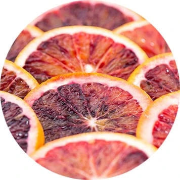 Overlapping slices of dried blood oranges showing deep red centers